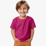 A boy wearing a pink organic cotton crew neck t-shirt.