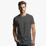 Man wearing a plain gray t-shirt against a white background