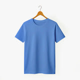 Blue t-shirt on a wooden hanger against a white background