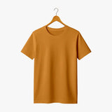 Mustard yellow t-shirt on a hanger against a white background