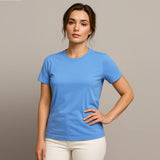 Woman wearing a blue t-shirt against a beige background