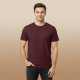 Man wearing a maroon t-shirt against a beige background