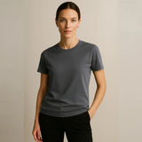 Woman wearing a gray t-shirt against a beige background