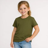Young girl wearing an olive green t-shirt and blue jeans on a white background